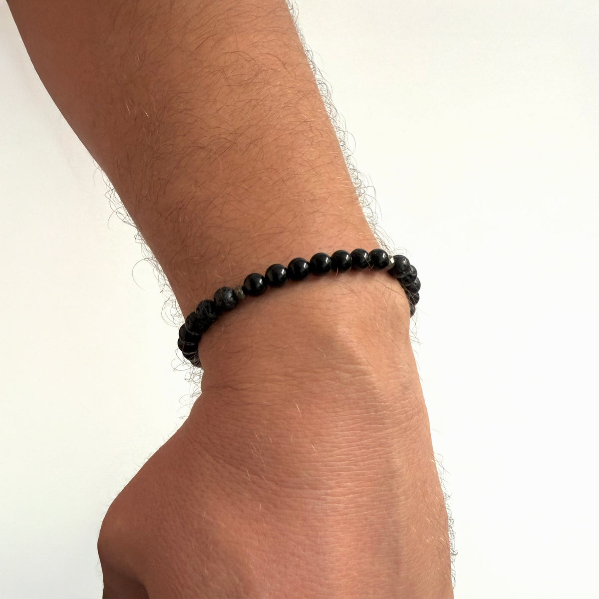 Inner Strength bracelet worn on a man's wrist against a white background