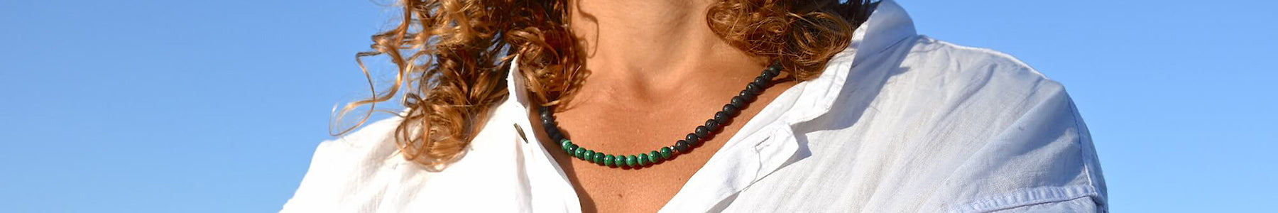 Mana for Men Hero Image: Stylish men's empowerment necklace featuring green Malachite and porous Lava Stone beads, offering protection, positive energy, and grounding for the modern man.