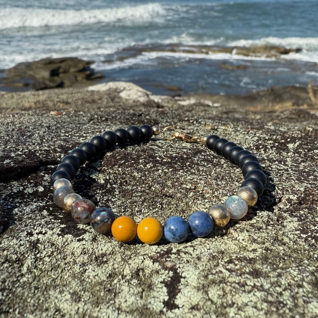 Phoenix Rising men's bracelet: black onyx with labradorite, pietersite, dumortierite and mookaite, on coastal rock