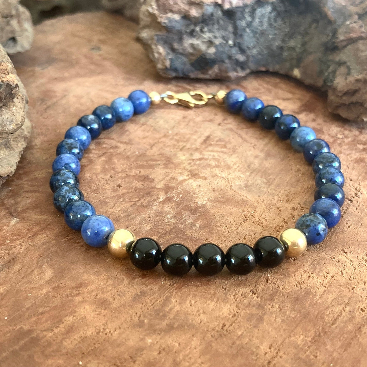 The Architect men's bracelet: blue dumortierite with black onyx and 14k gold-fill beads, on wood