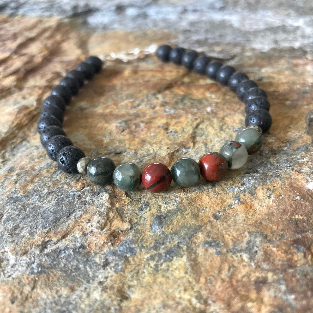 Close-up of bloodstone beads with red flecks on the Strength bracelet