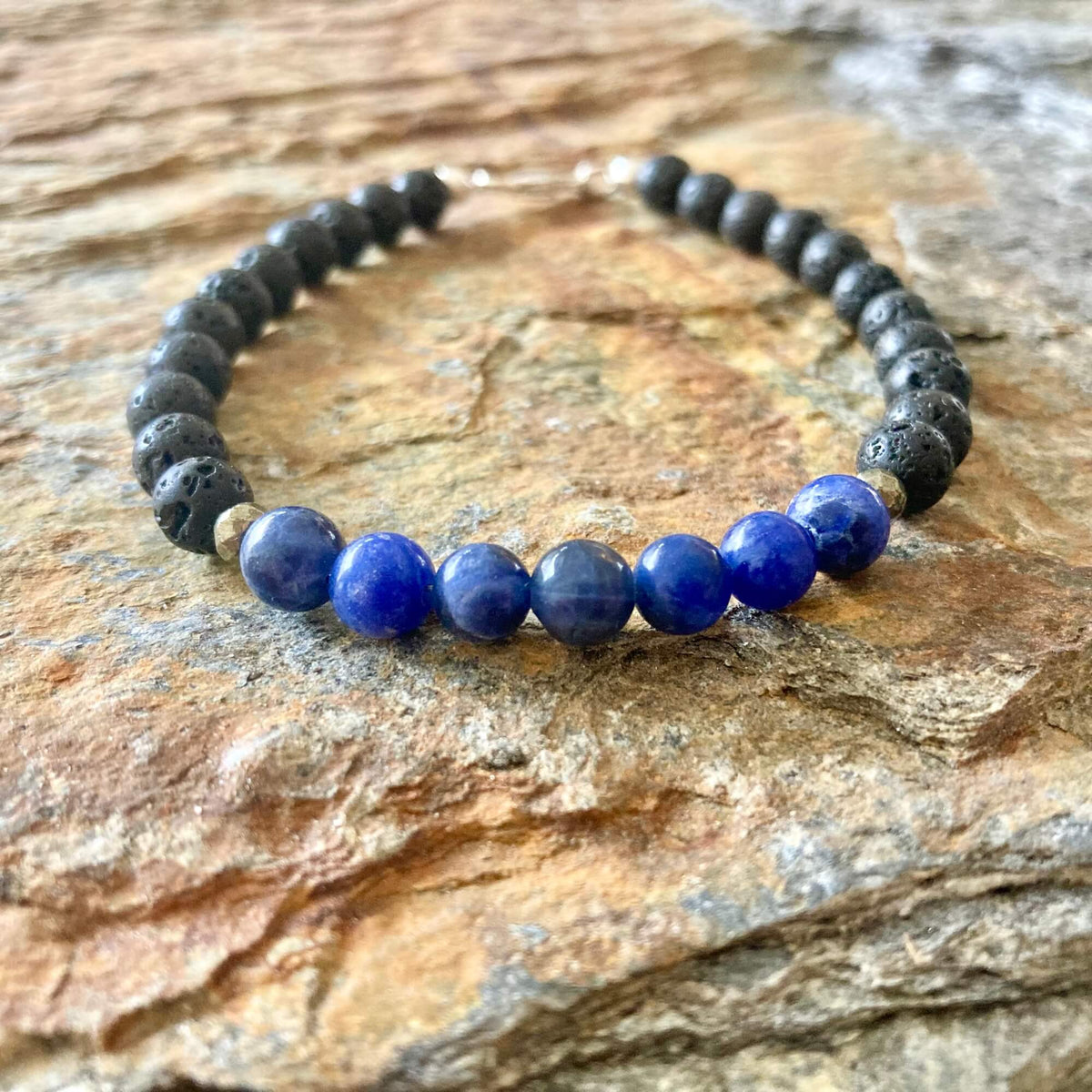 Close-up of deep blue sodalite beads with white veins on the Focus bracelet