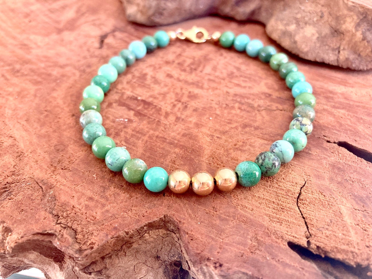 Close-up of gold-fill beads among green chrysoprase on The Wayfinder bracelet