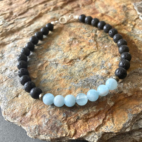 Courage bracelet on orange-veined sandstone, aquamarine beads at the front