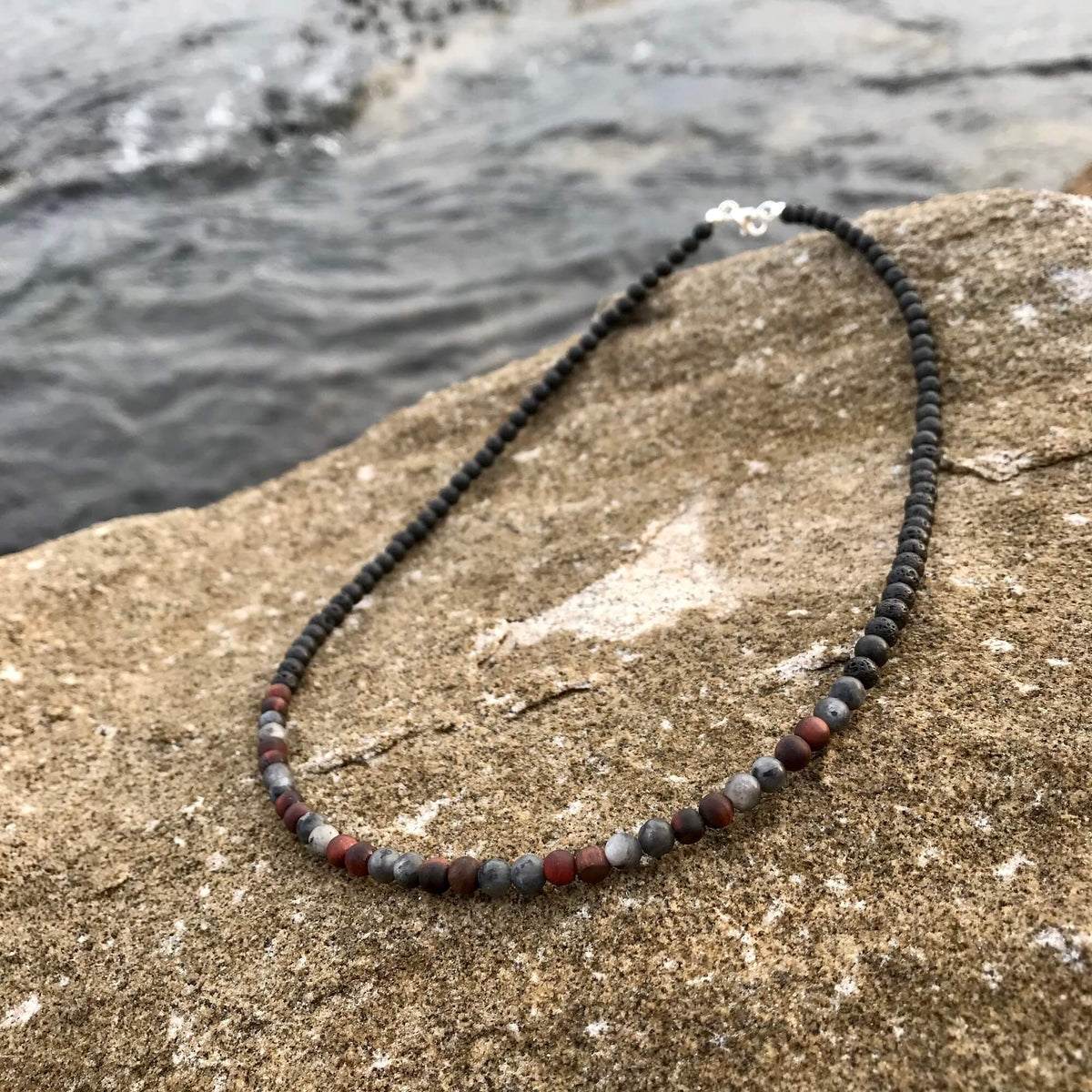 Drive necklace laid on a sandstone rock