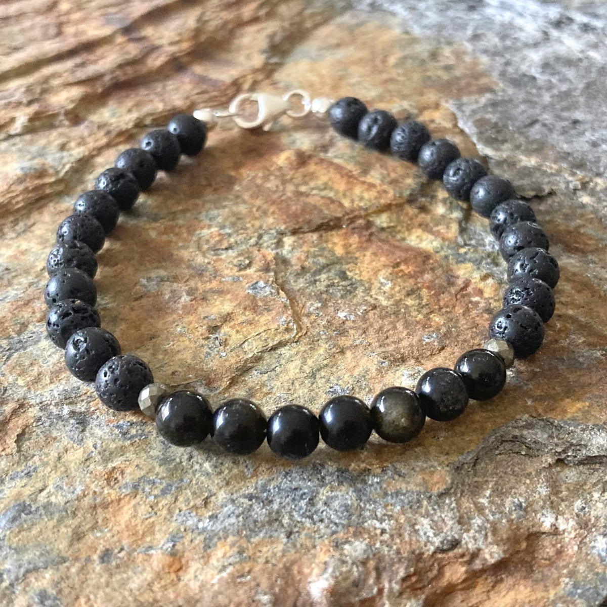 Facing Fears bracelet on orange-veined sandstone, sterling silver clasp at the top