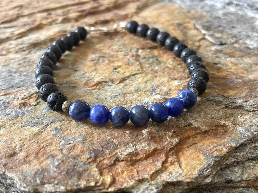 Focus bracelet from above on sandstone, sterling silver clasp at the top