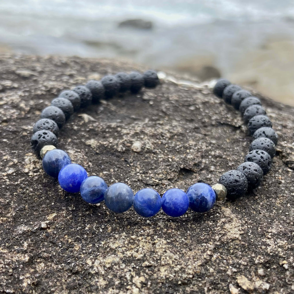 Focus bracelet on dark rock, seen from a low angle