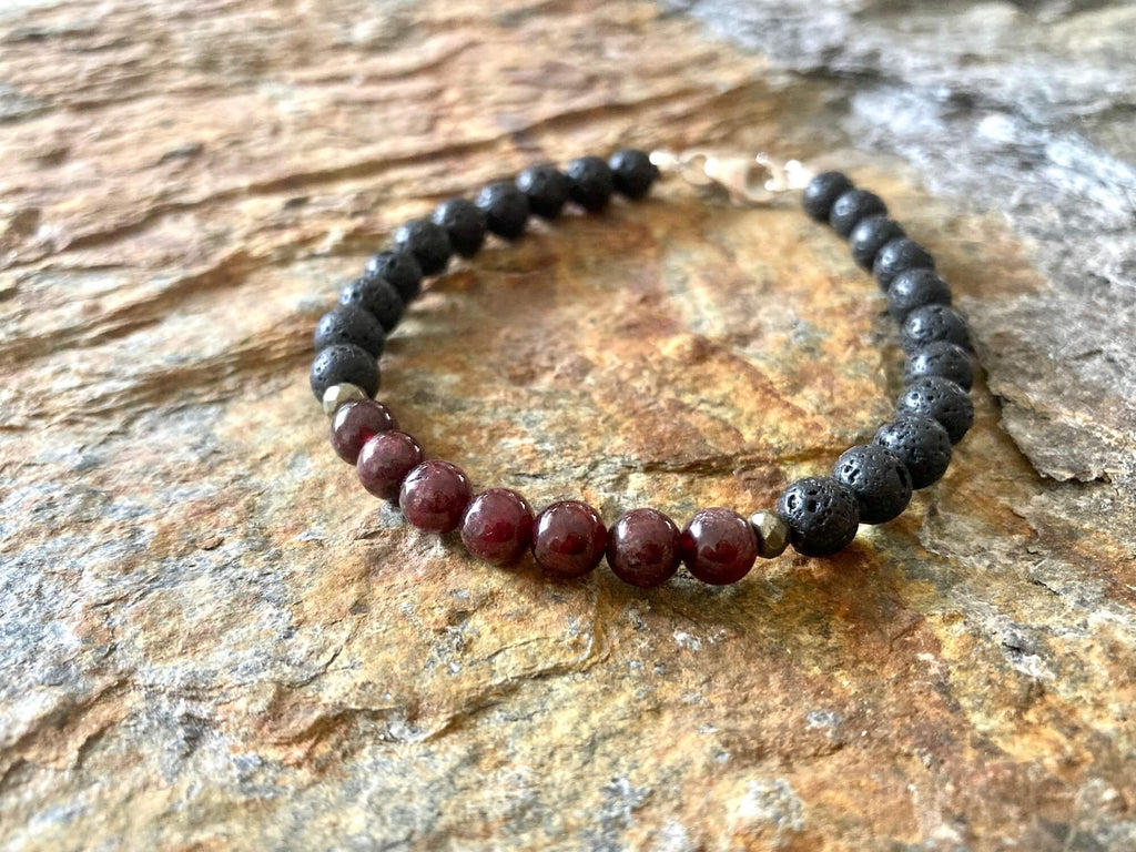 Garnet beads between black lava stone on the Prosperity bracelet