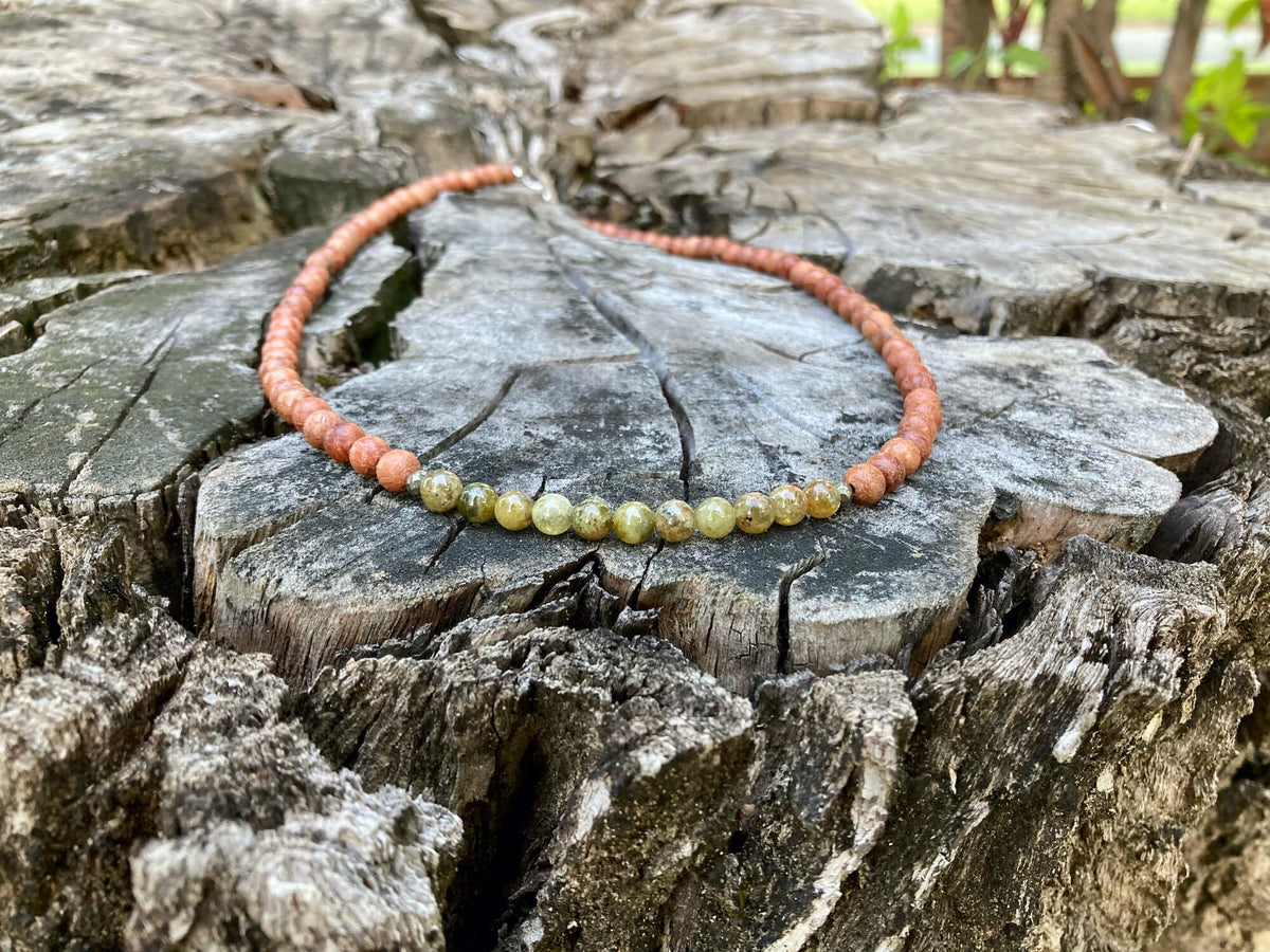 Growth necklace on old timber, sterling silver clasp at the top