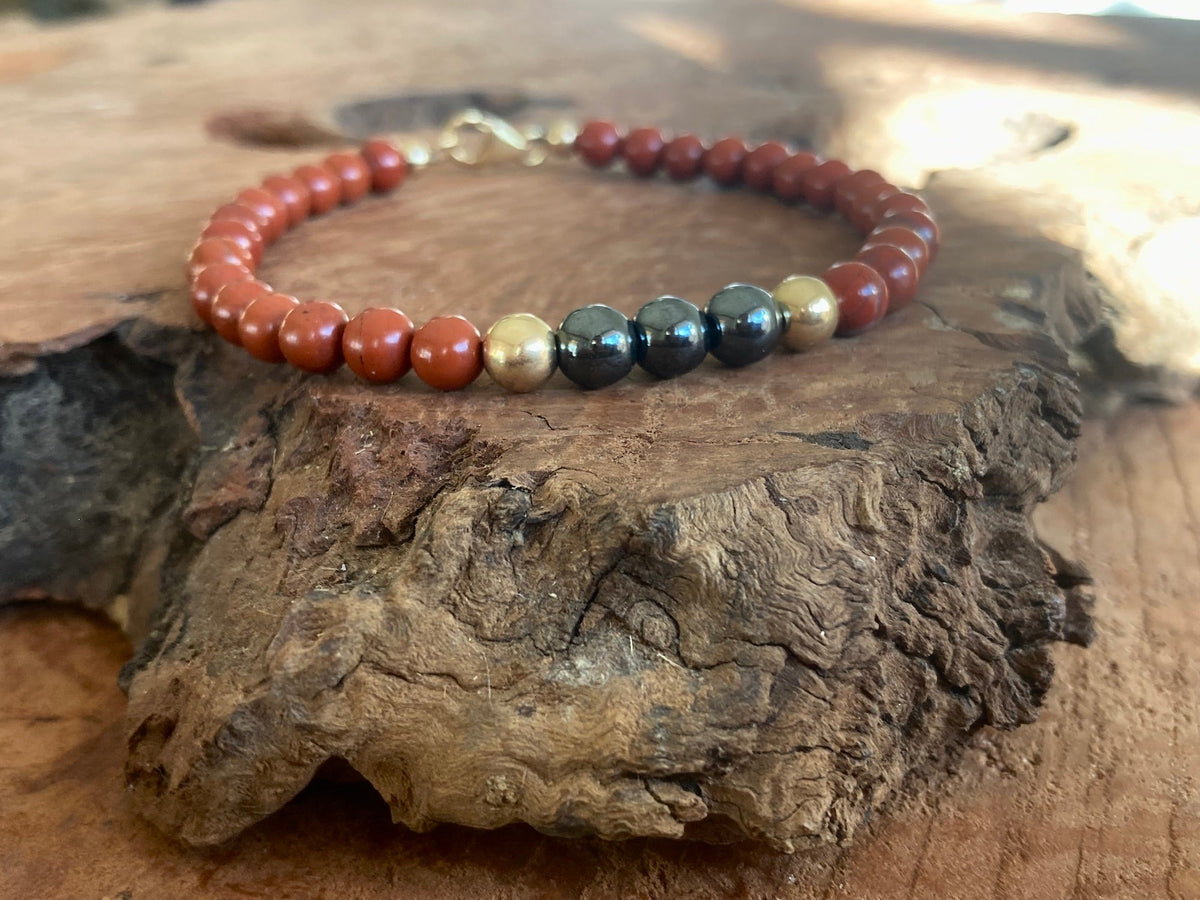 Hematite beads framed by gold-fill and red jasper on The Steadfast bracelet