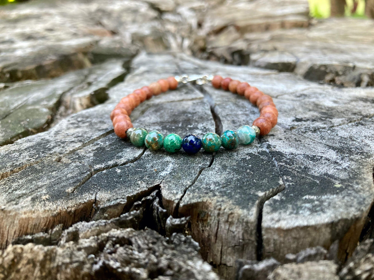 Inner Wisdom azurite bracelet on a tree stump in daylight