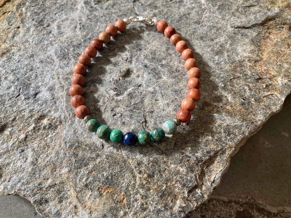 Inner Wisdom bracelet on grey rock, seen from above