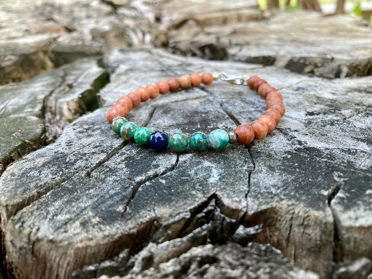 Inner Wisdom bracelet on an old stump, seen from further back
