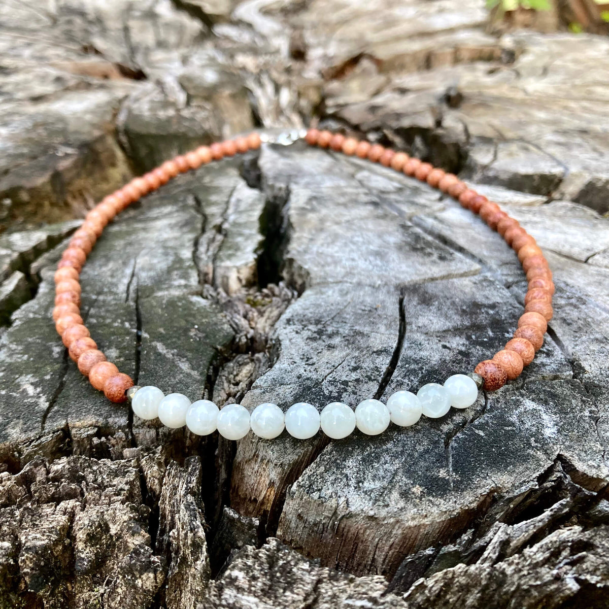 Moonstone and natural wood men's necklace on cracked timber