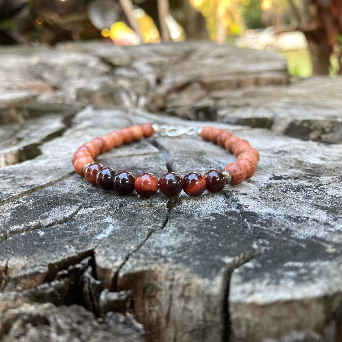 Motivation men's bracelet: red tiger's eye with natural wood beads, on a weathered stump