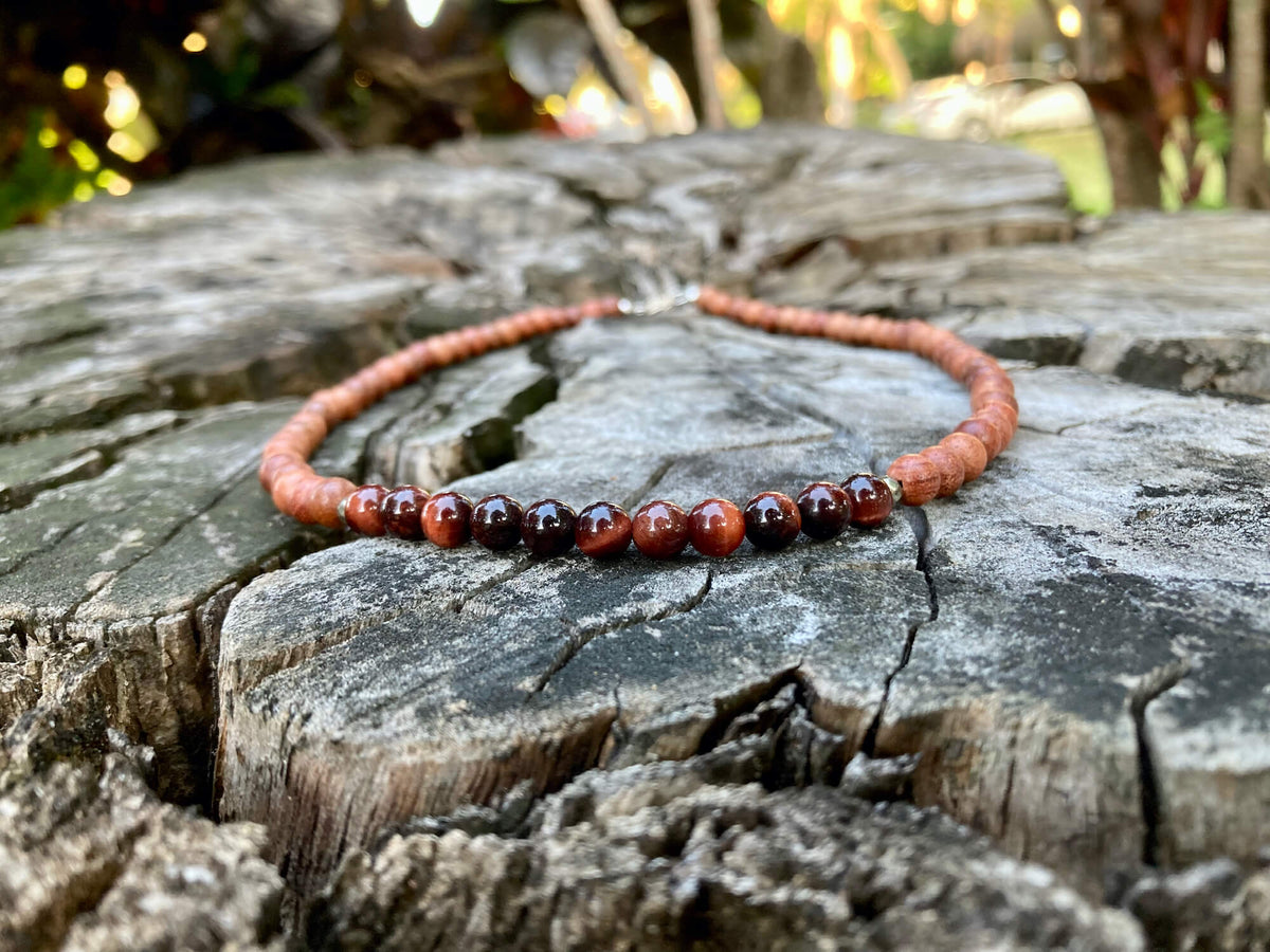 Motivation necklace on old timber, seen from a low angle
