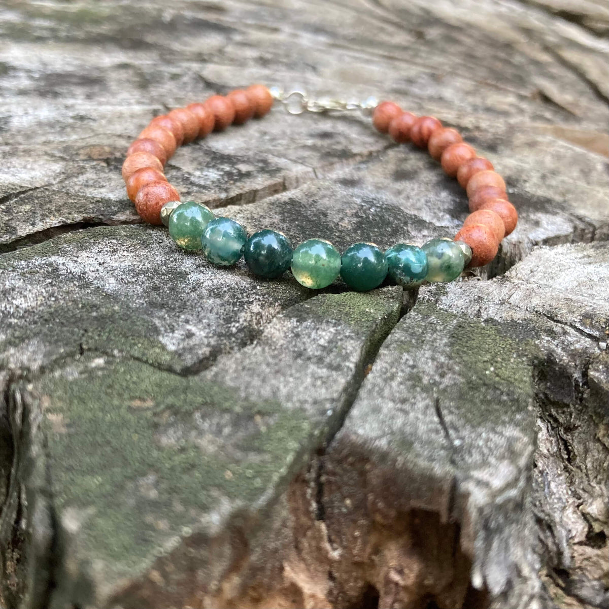 New Beginnings men's bracelet: green moss agate with warm natural wood beads, on a weathered stump