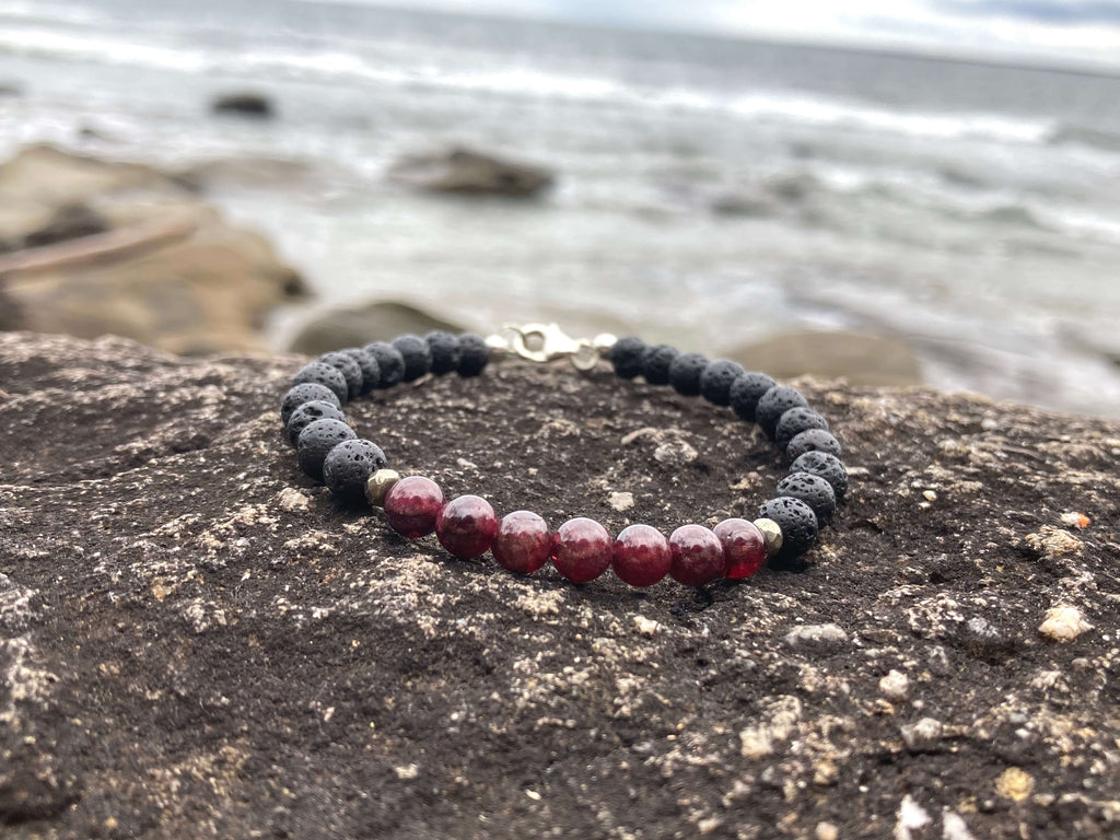 Prosperity bracelet on a rock ledge by the water