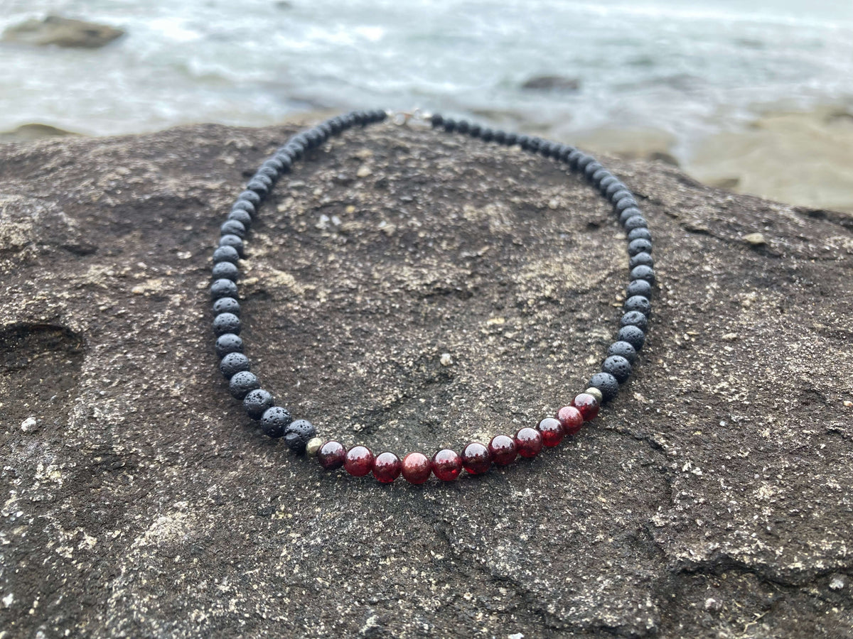 Prosperity necklace on a flat coastal rock