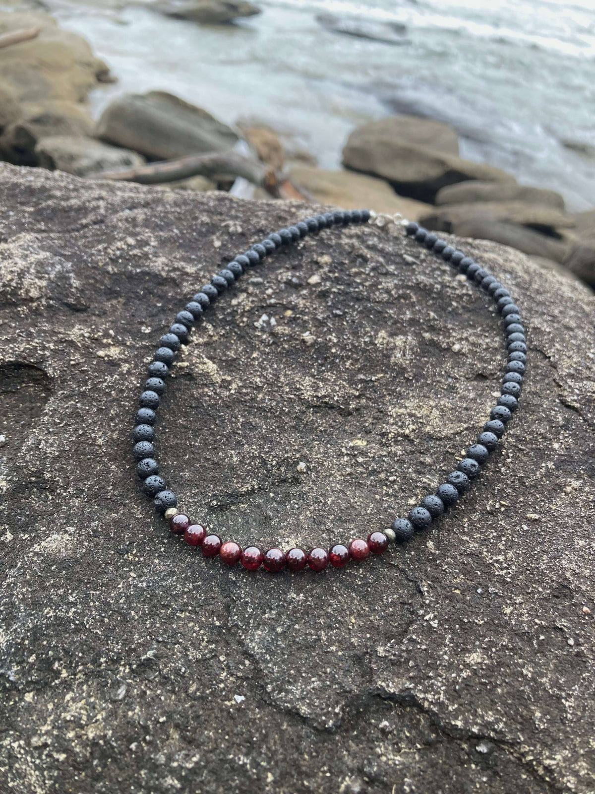 Prosperity necklace on rock, seen from further back