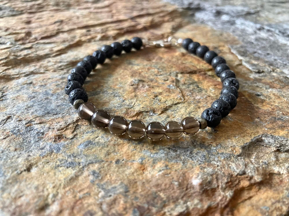 Self-Assurance bracelet from above on sandstone, sterling silver clasp at the top