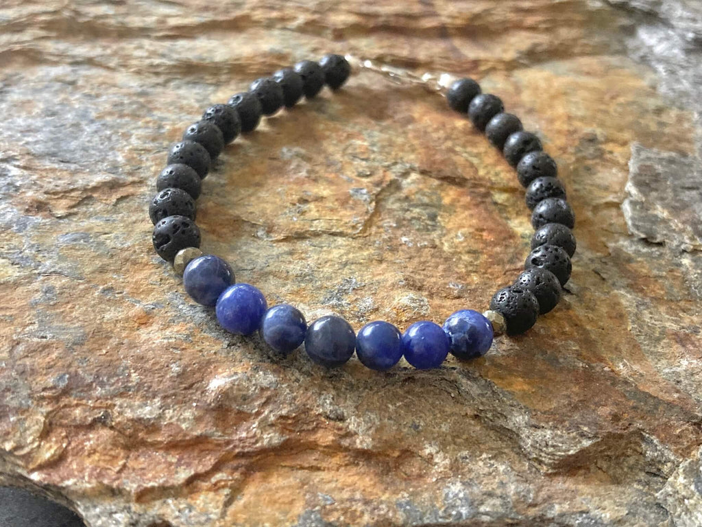 Sodalite and lava stone men's bracelet on golden sandstone