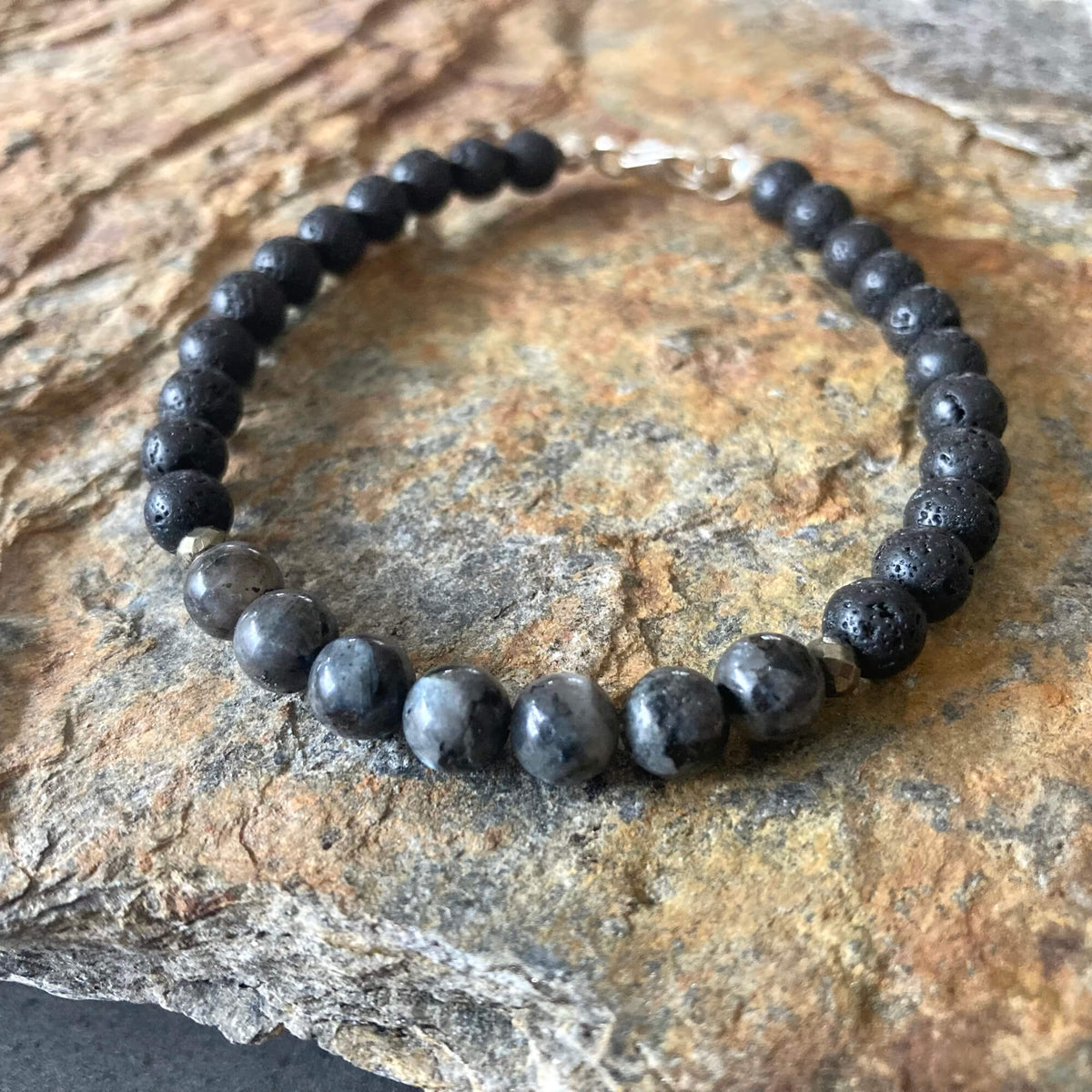Transformation bracelet on orange-veined sandstone, larvikite beads at the front