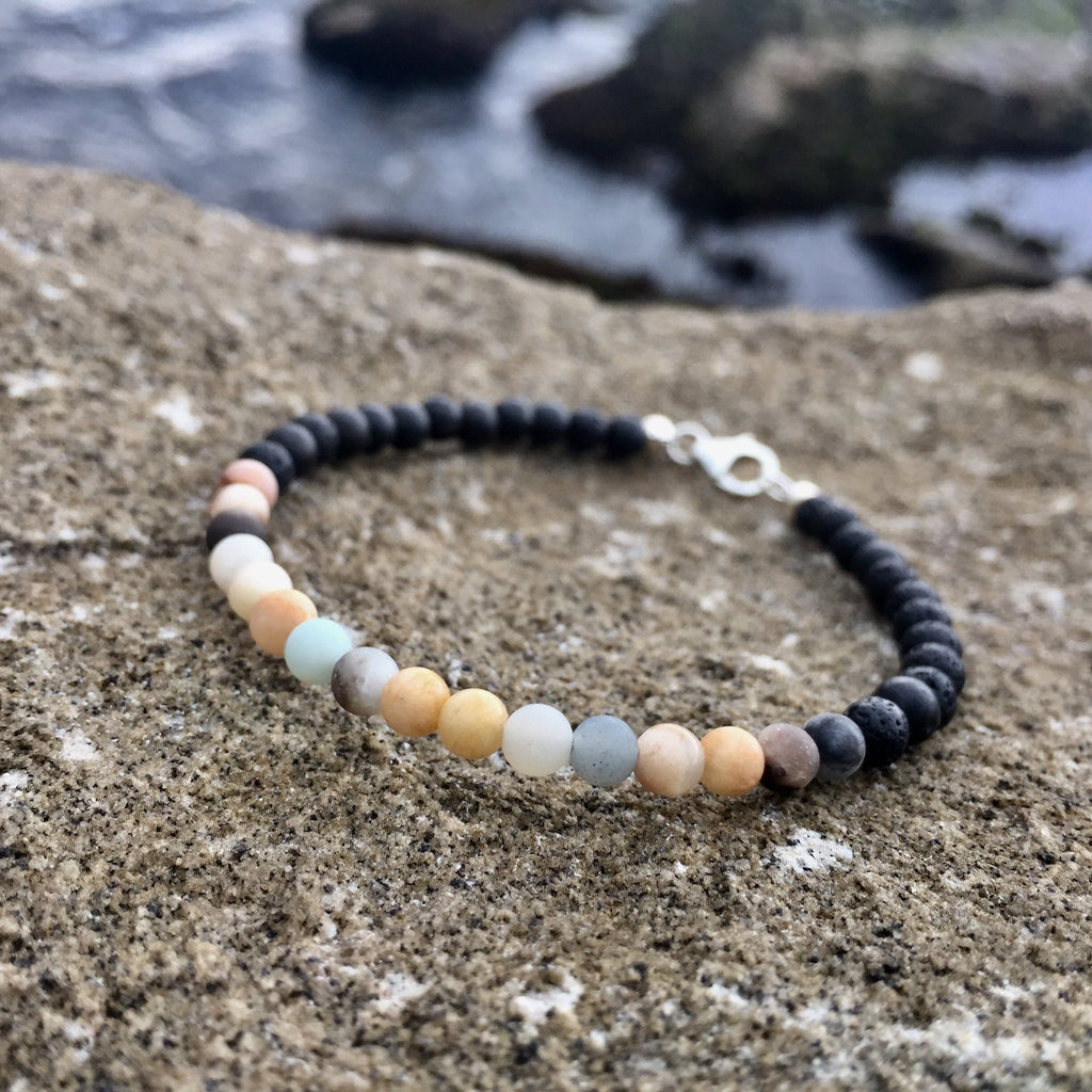 Vitality men's bracelet: peach sunstone and pale blue amazonite with black beads, on sandstone