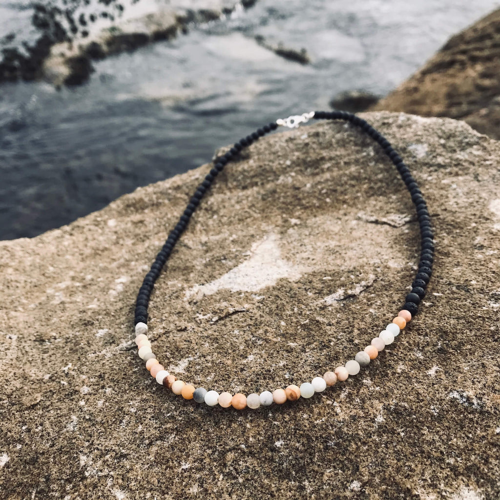 Vitality men's necklace: peach sunstone and pale blue amazonite with black beads, on sandstone