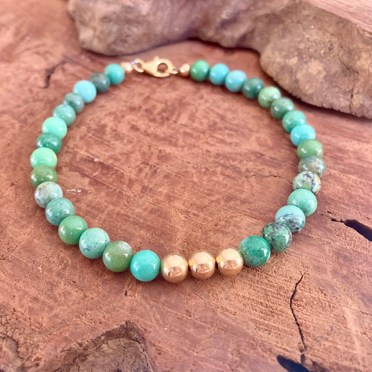 The Wayfinder bracelet's mottled green chrysoprase beads, seen from above